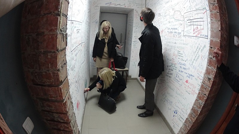 Players are solving a puzzle in an escape room.