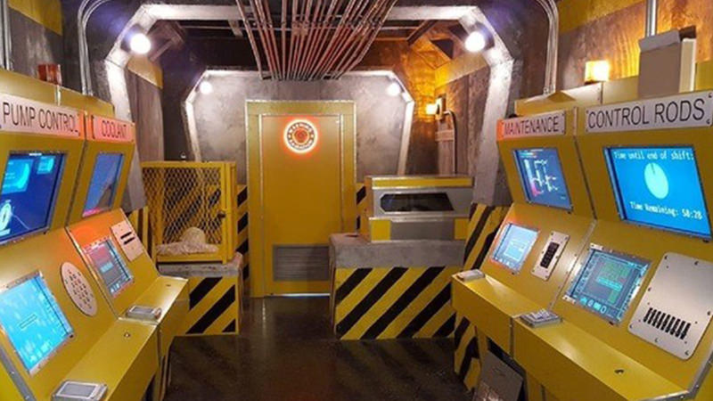 Old-fashioned arcade escape room with primitive consoles.