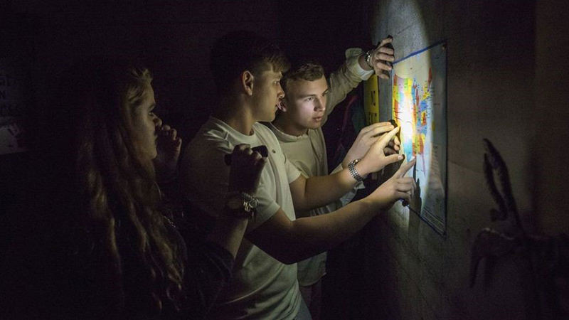 Team of young people is trying to see what’s inside a locked house from the outside.