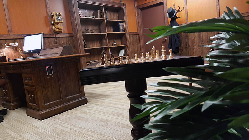 The chess table in the middle of the room is only a minor puzzle element. To get out, your employees will have to solve many riddles together.