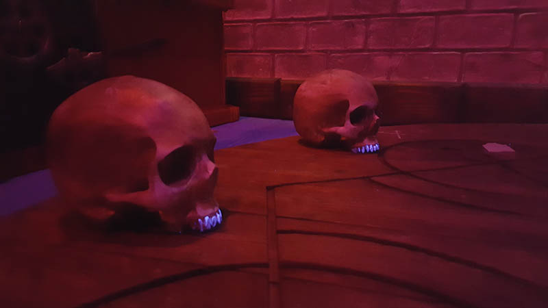 There are old human skulls on the floor. Perform a dark magic ritual with them, and you’ll unlock the exit.